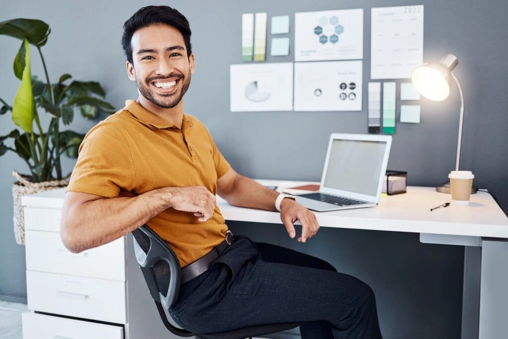 An SEO consultant sitting at his desk and smiling at a client.