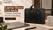 Vegetable-tanned leather laptop sleeve for a 15.6-inch laptop, showing padded interior and slim front pocket for accessories