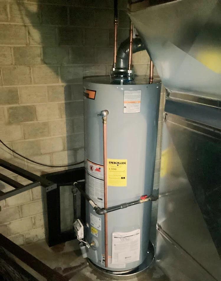 A gas water heater in a house basement
